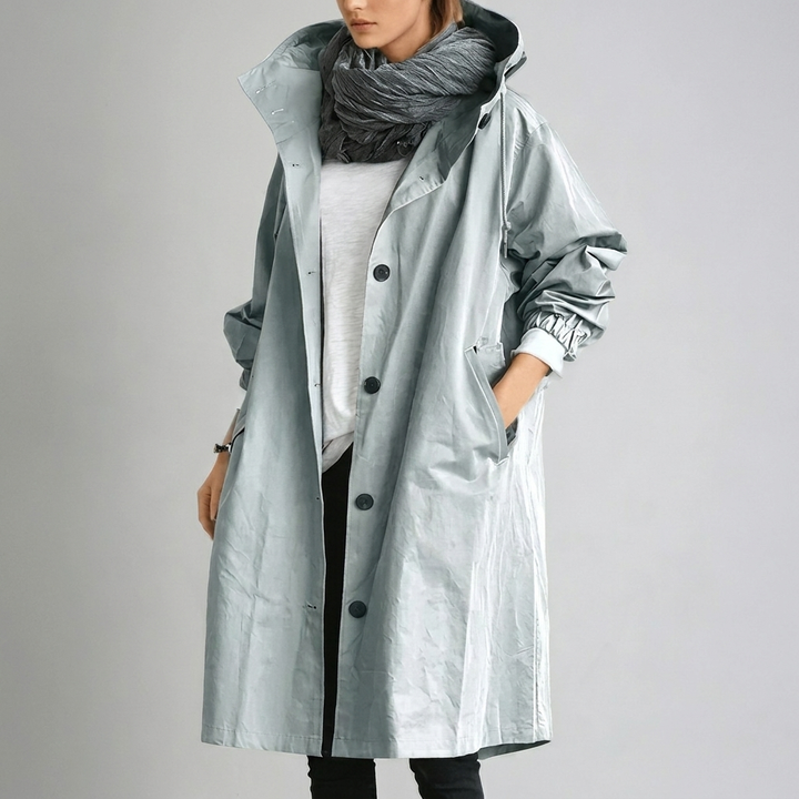 Women's Raincoat in pale sage-gray with hood and a slightly glossy, wrinkled finish.