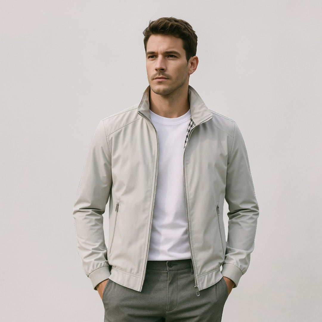 Model wearing the light gray jacket open over a white tee, with a black-and-white checked lining visible at the collar. 5