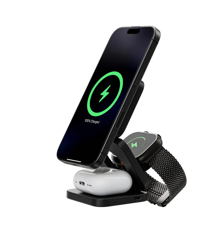 Black foldable magnetic wireless charging station, another view, with a phone, smartwatch and earbuds case charging upright.