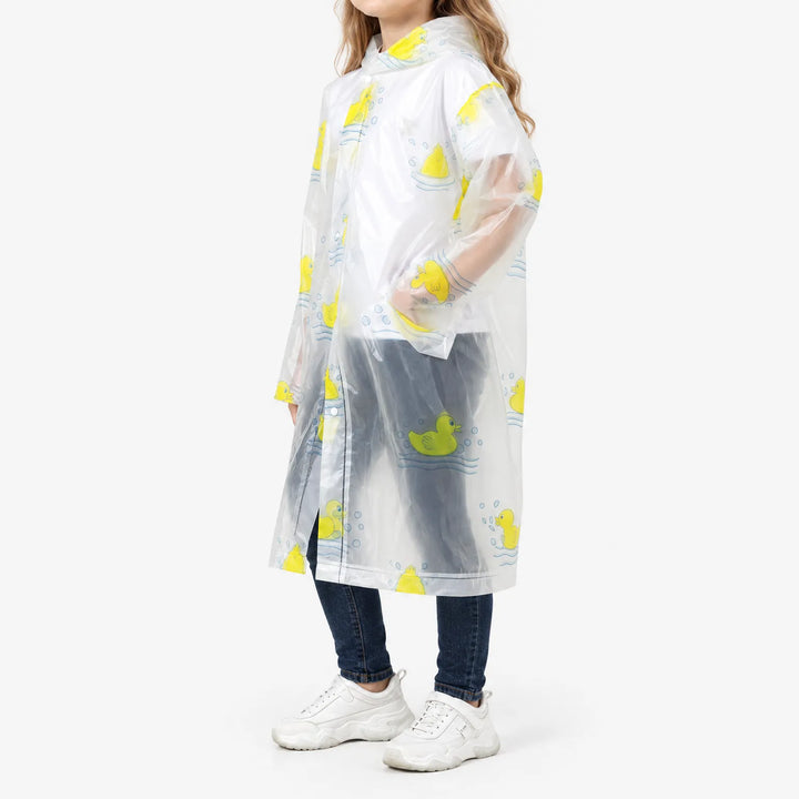 Side view of a girl in the clear duck-print raincoat, showing the long cut, side pocket opening and snap closure. 5
