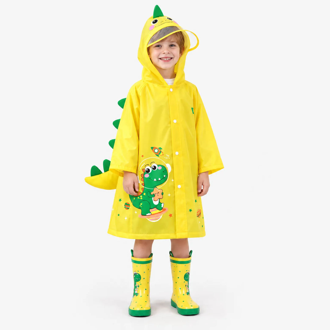 Smiling boy wearing a yellow dinosaur raincoat with green spikes and a tail, plus matching yellow rain boots, on a white background. 2