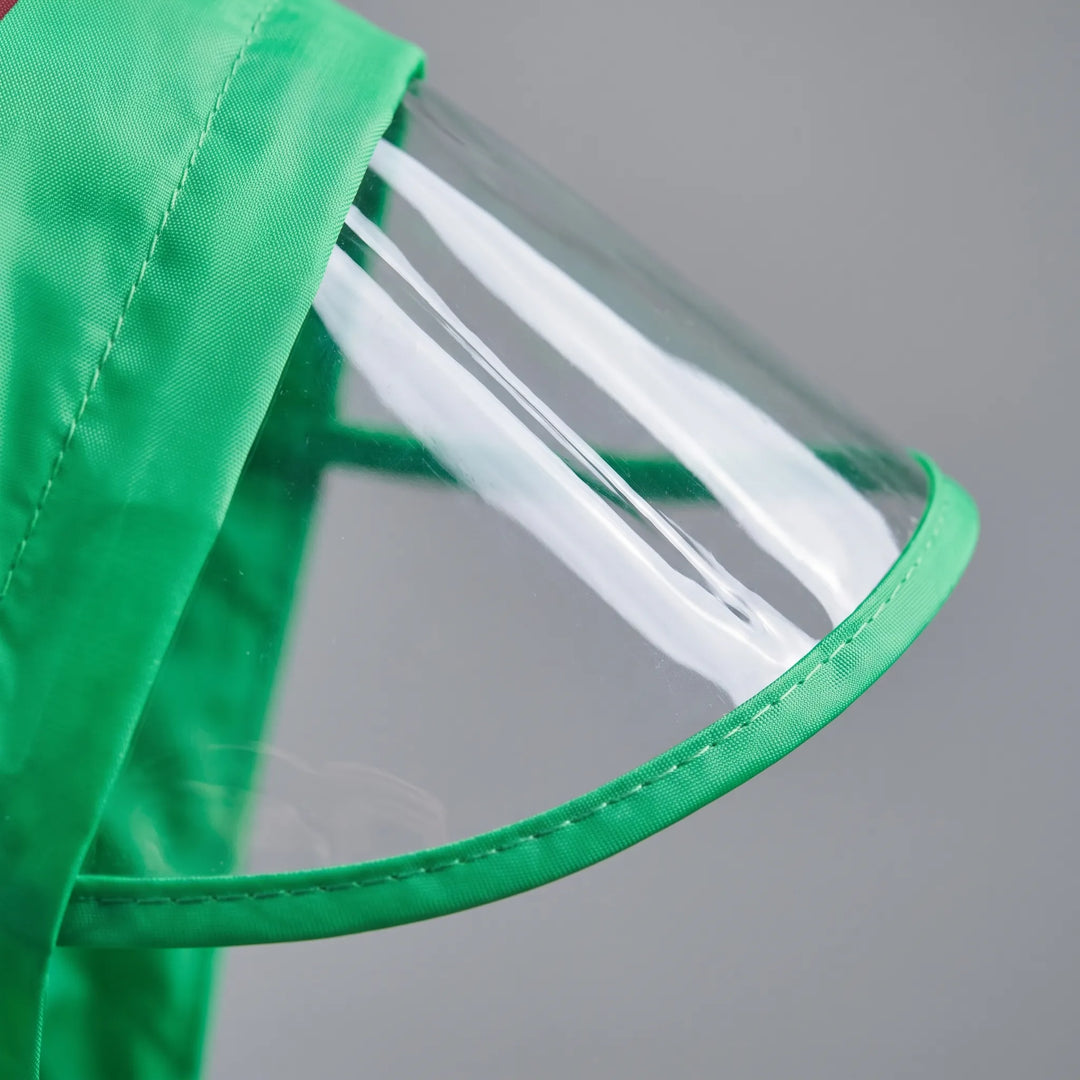 Close-up of the transparent hood brim edged in green fabric with stitched trim on the green jumpsuit. 6