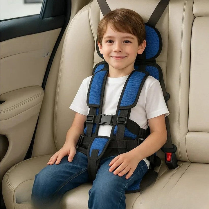 Royal blue foldable kids travel seat harness on a beige back seat.