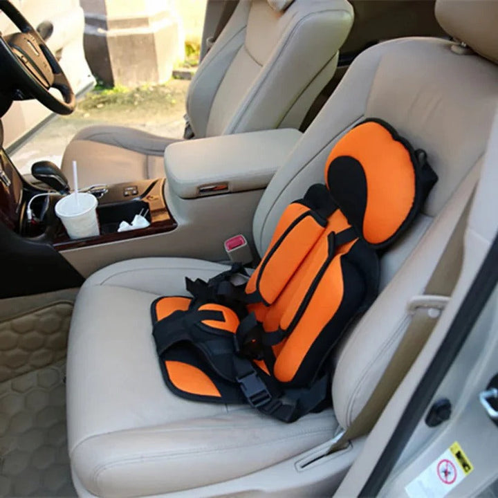 Blue foldable kids travel seat with harness, empty view.