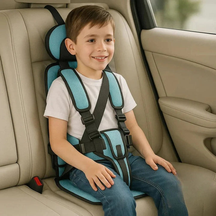 Light teal foldable kids travel seat on a rear car seat.