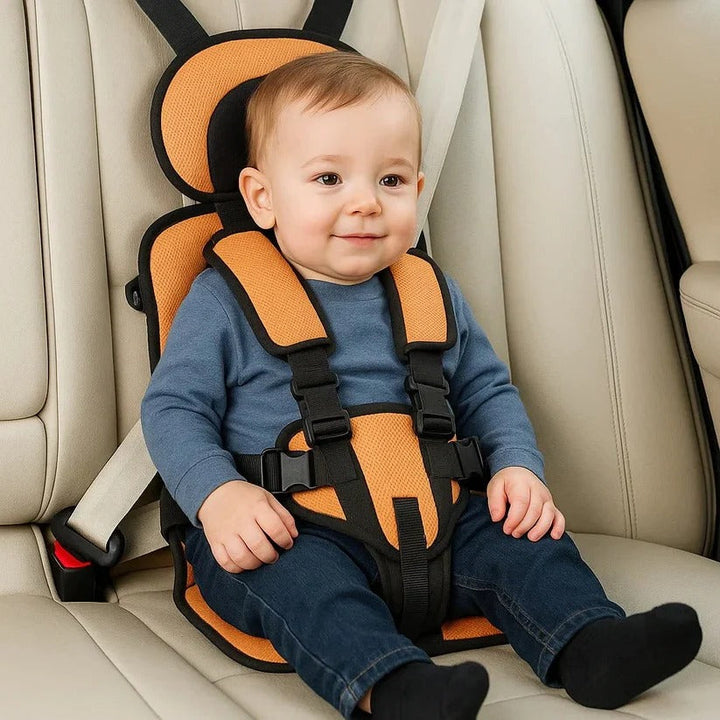 Orange foldable kids travel seat with black harness and buckles.