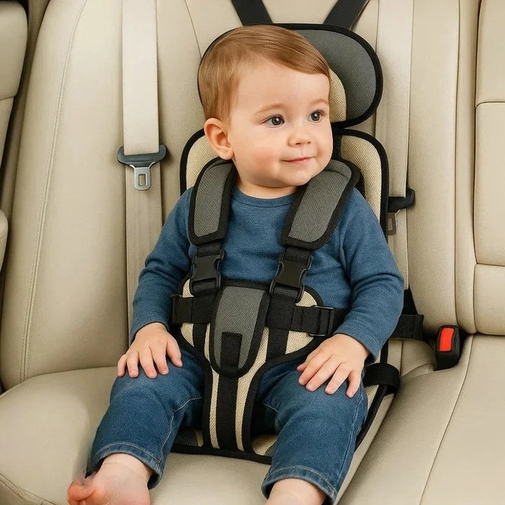 Gray and cream striped foldable kids travel seat with black harness fastened.