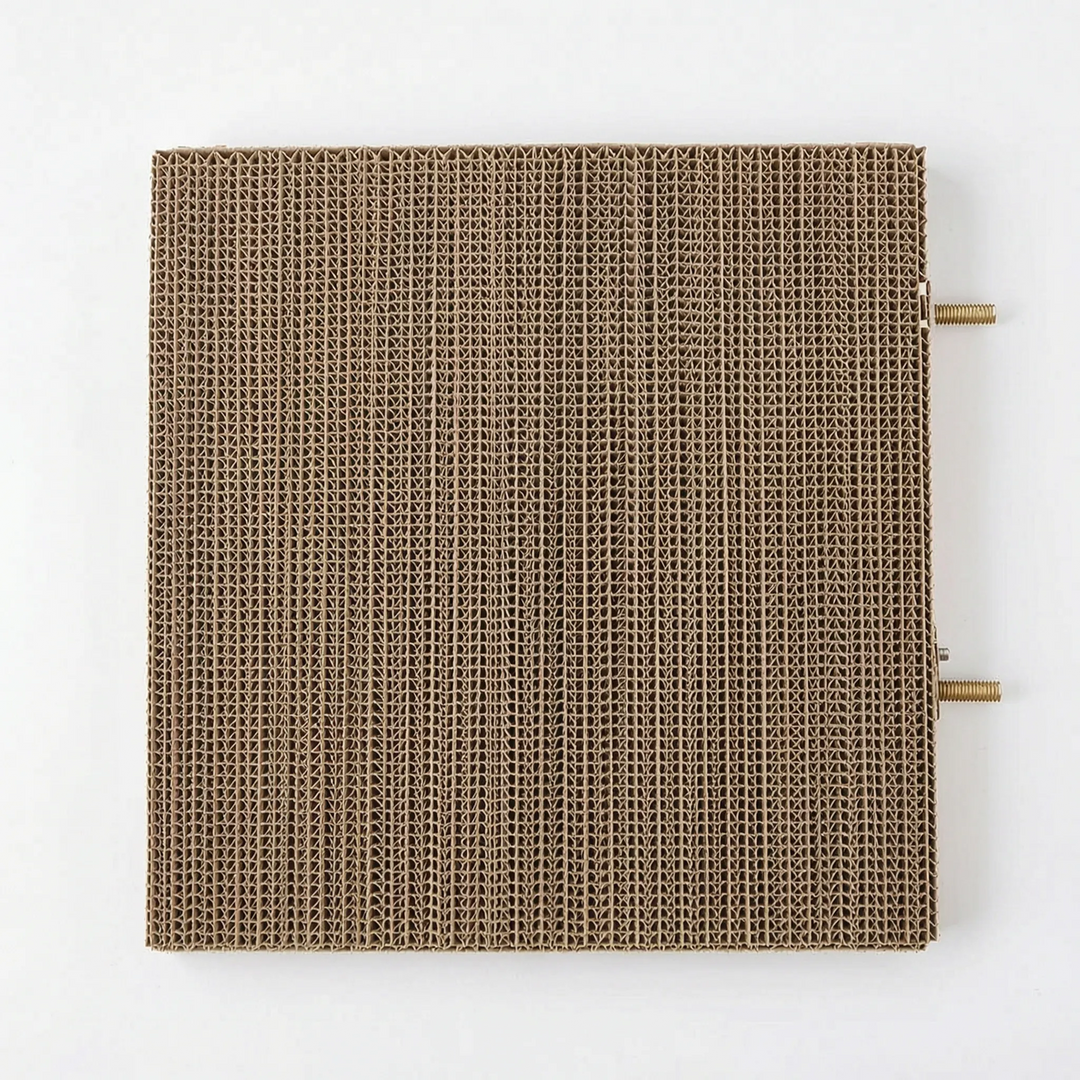 Top-down view of the square corrugated cardboard platform, with two threaded brass mounting bolts sticking out from one side. 5