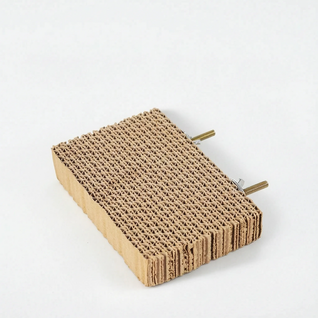 Smaller cardboard platform seen at an angle, with two threaded brass mounting bolts and nuts attached to the back edge. 7
