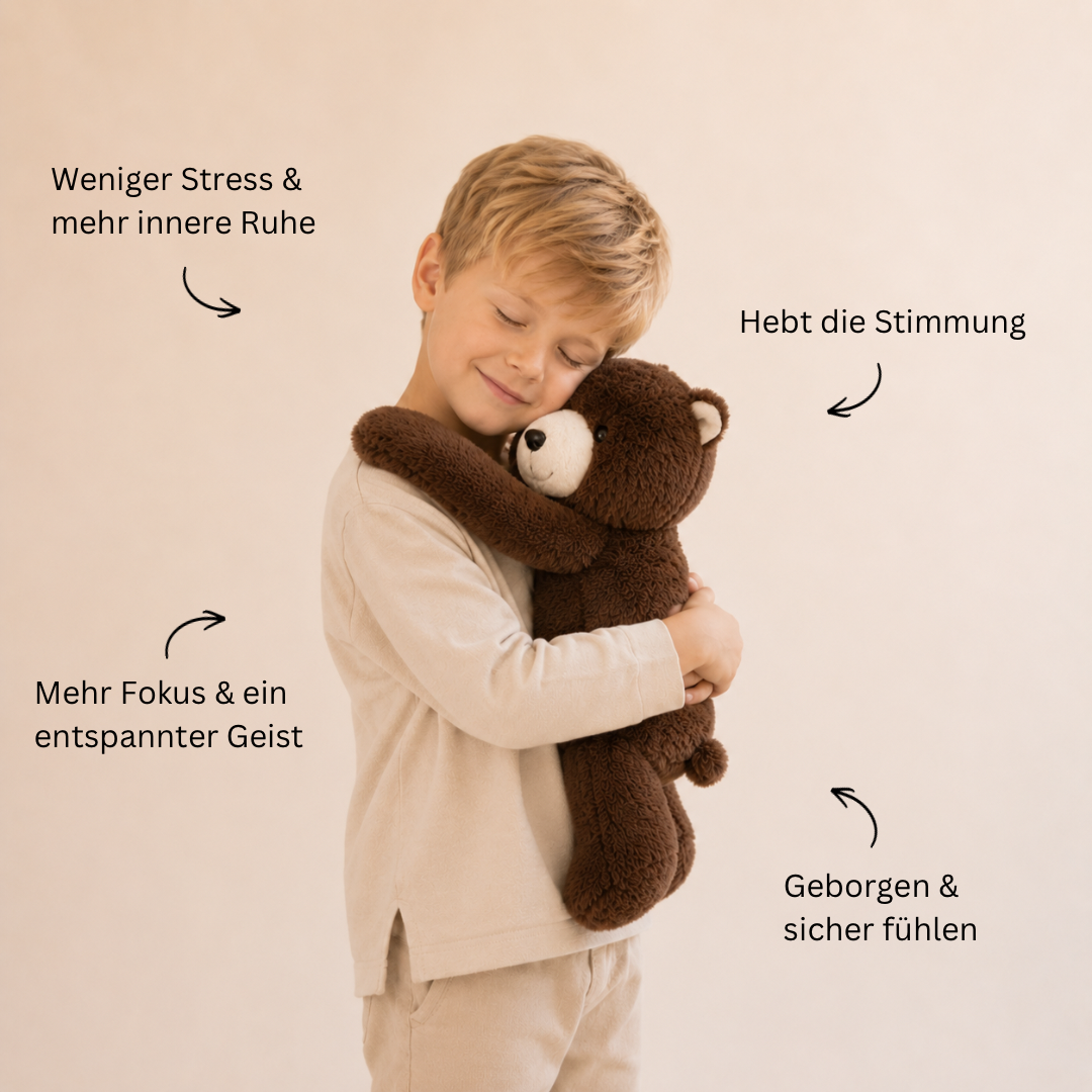 Smiling boy with eyes closed hugging a dark brown teddy bear plush against his cheek, wearing a cream sweater. 7