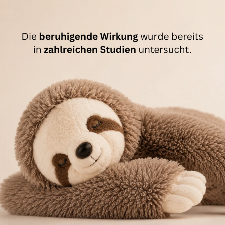 Close-up detail of the sloth plush showing shaggy brown fur and closed embroidered eyes.