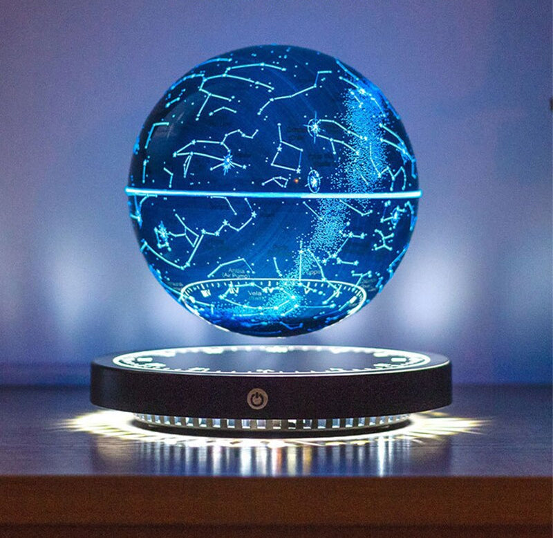 Bright blue glowing star map globe levitating over its round base against a soft blue background.