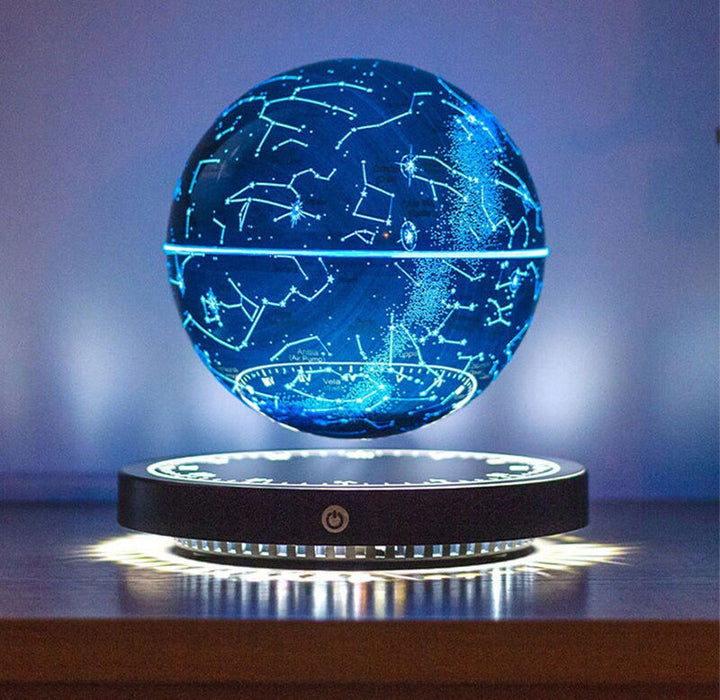 Bright blue glowing star map globe levitating over its round base against a soft blue background.