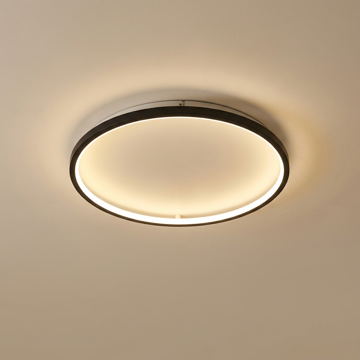 Round ceiling light with a black outer frame and a warm glowing inner ring 3