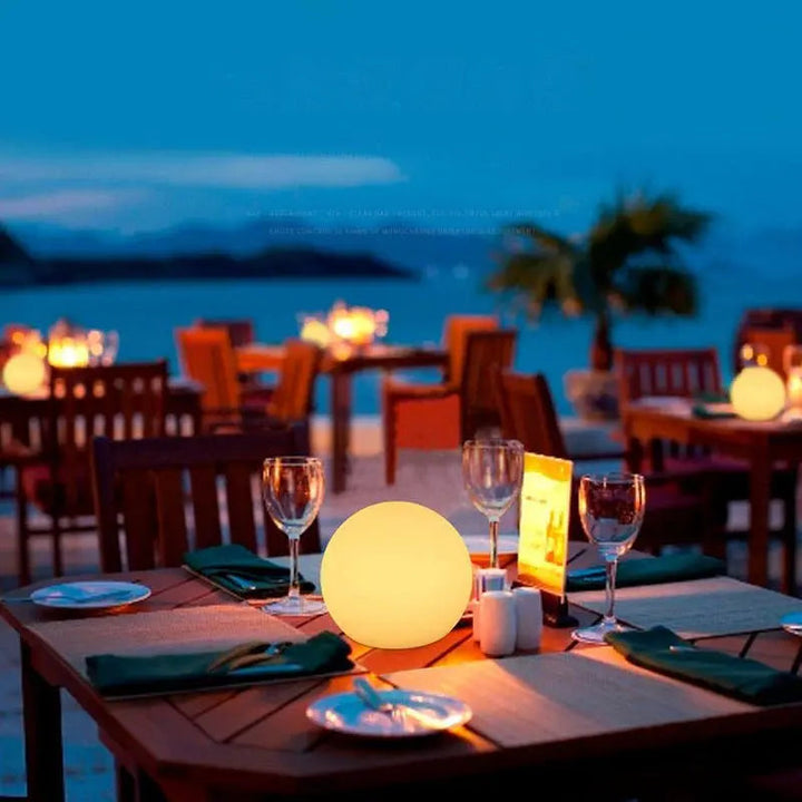 White orb lamp on an outdoor dining table