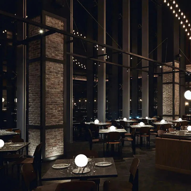 White orb lamps on dining tables in a restaurant