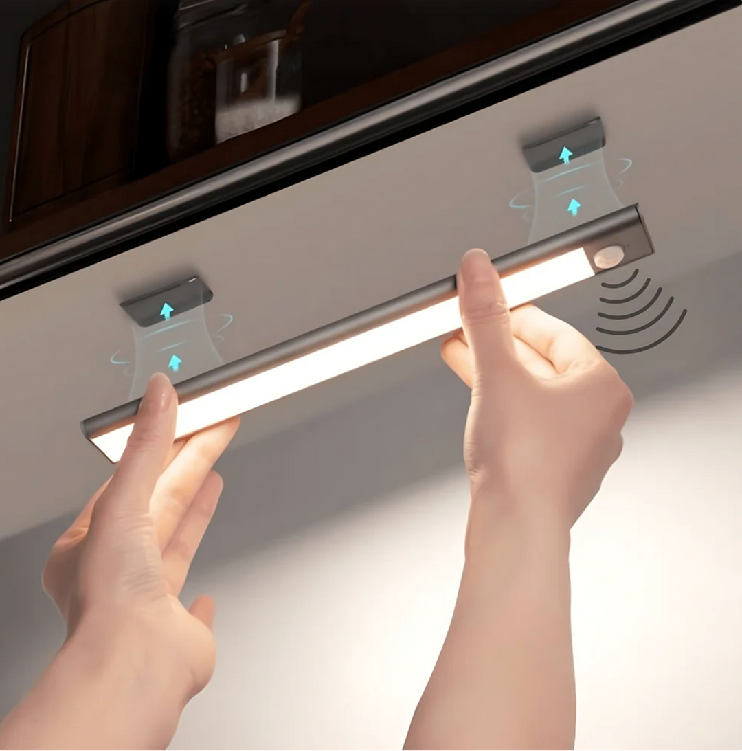 LED Under-Cabinet Light with Motion Sensor, Magnetic, No Drilling held under a kitchen cabinet with magnetic plates.