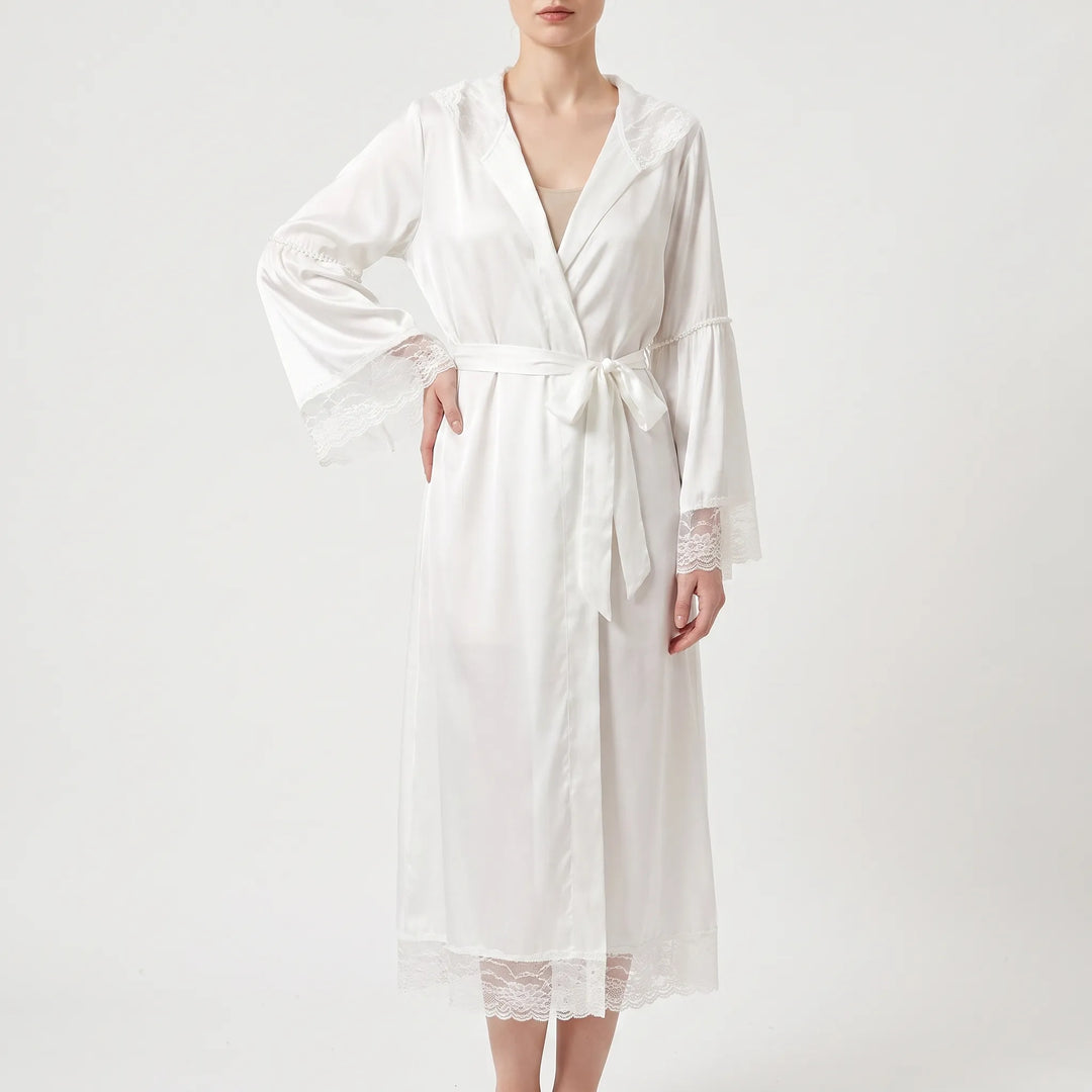 Model wearing the white satin version of the robe, belted at the waist, with lace on the hood, cuffs and hem. 5