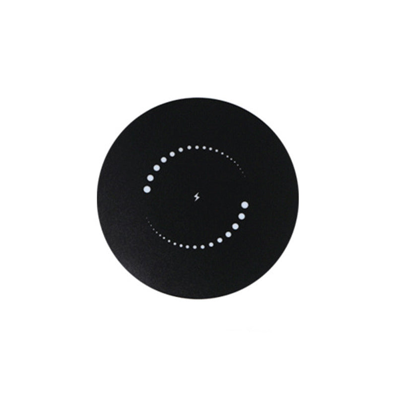 Top view of the black disc surface with a ring of white dots and a small lightning bolt at the center.