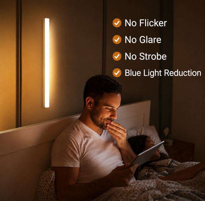 White motion sensor LED light bar shown as another view on the wall beside a bed.