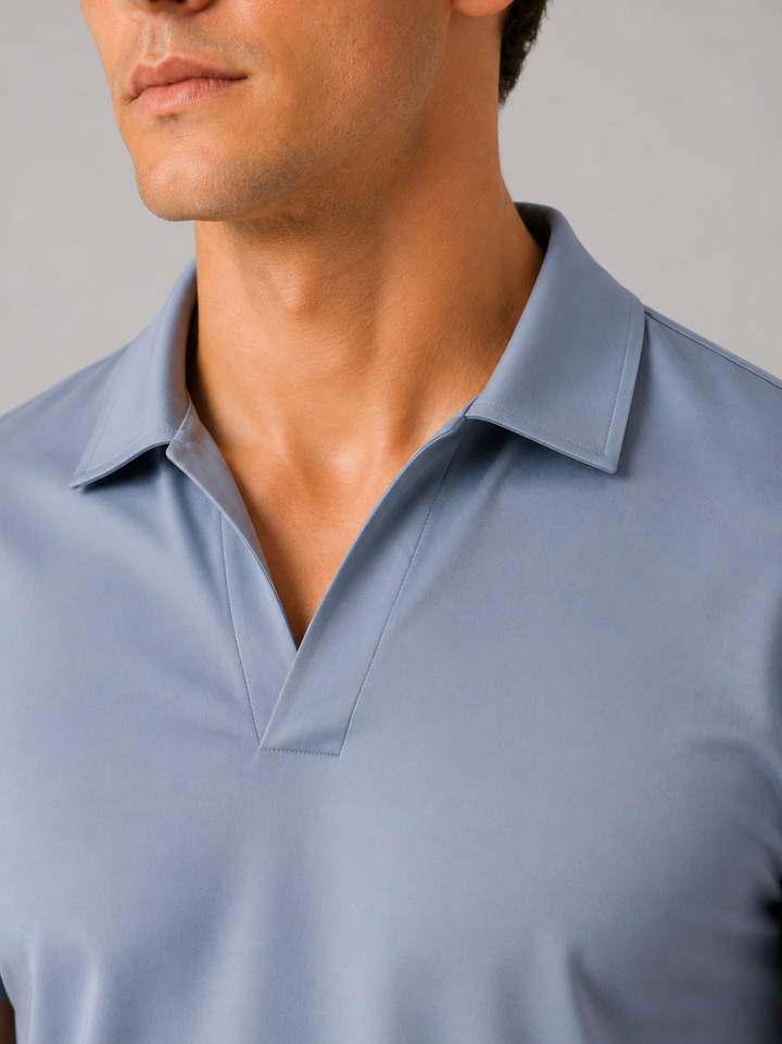 Dusty blue silky touch polo shirt detail of the V neckline and collar.