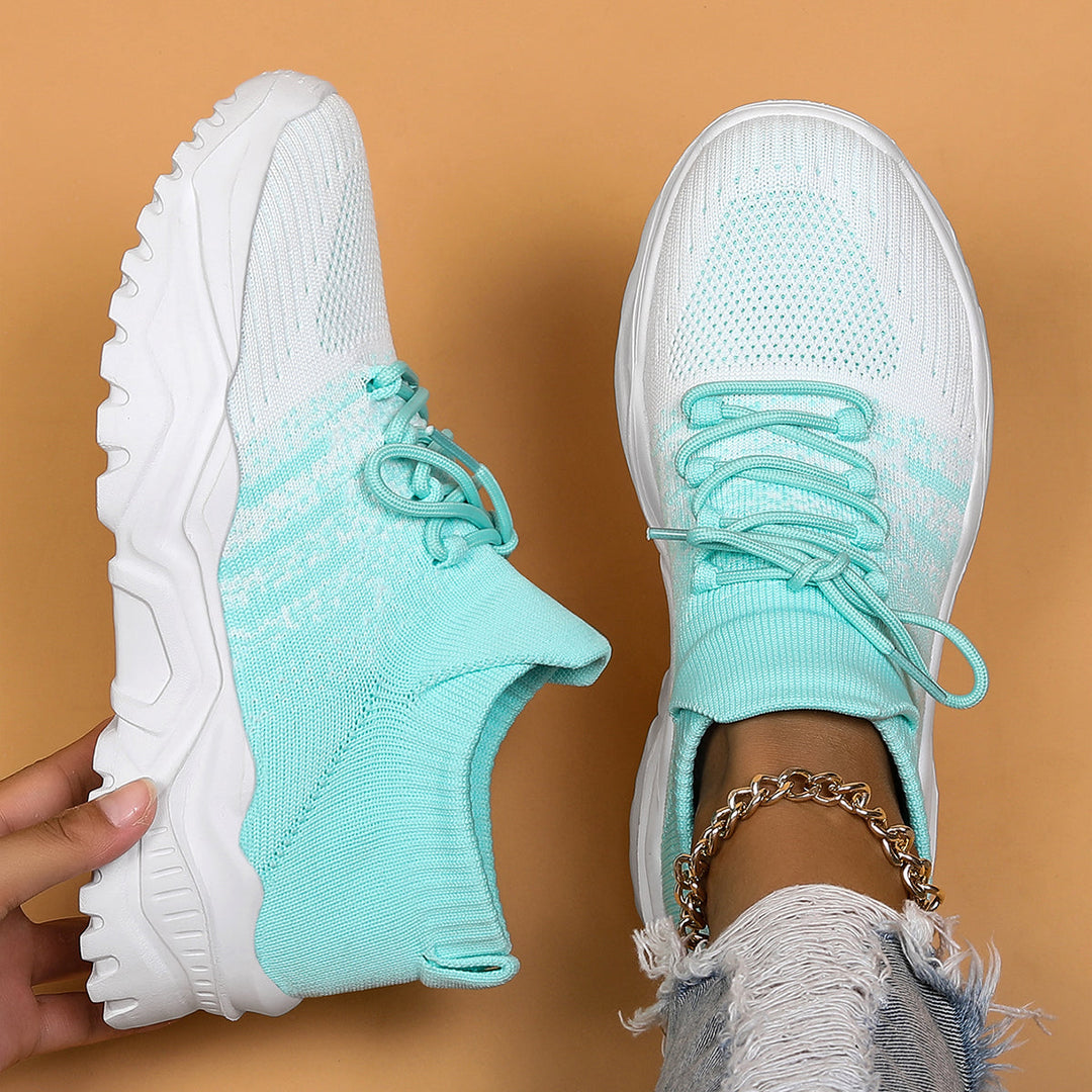 Mint green and white gradient knit sneakers with matching laces, top-down view.