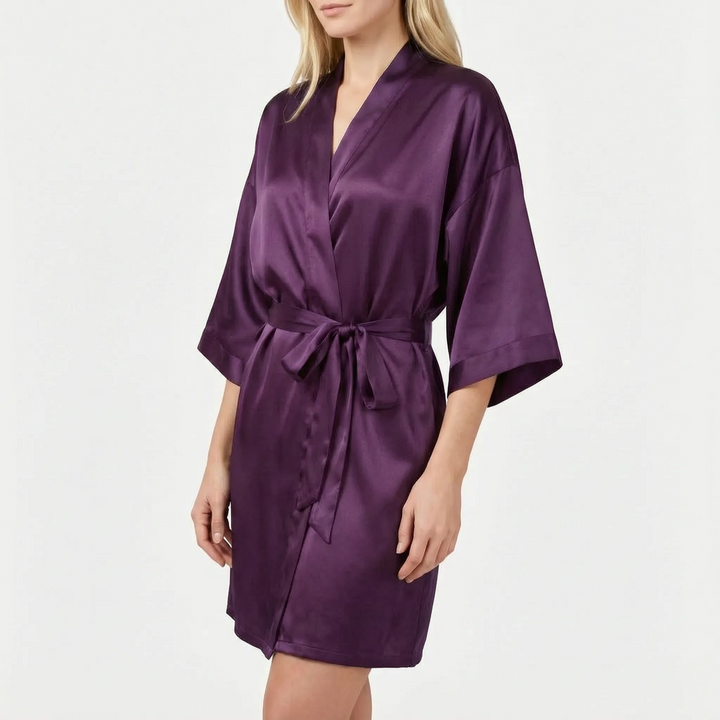 Model wearing the robe in dark plum purple satin with a tied belt and kimono-style sleeves. 13