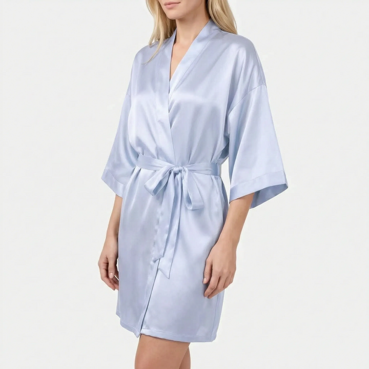 Model wearing the robe in pale powder blue satin with a tied belt and wide three-quarter sleeves. 6