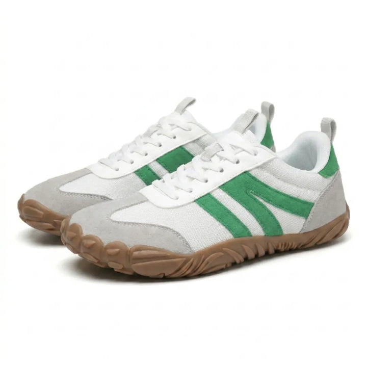 Pair of white mesh barefoot sneakers with green suede stripes, gray toe caps and a tan gum sole, shown at an angle. 34