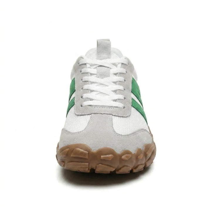 Front view of the white and green sneaker showing the gray suede toe cap, white laces and broad tan gum sole. 35