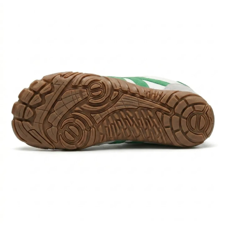 Underside of the white and green shoe showing the tan gum outsole with a detailed grip tread pattern. 36