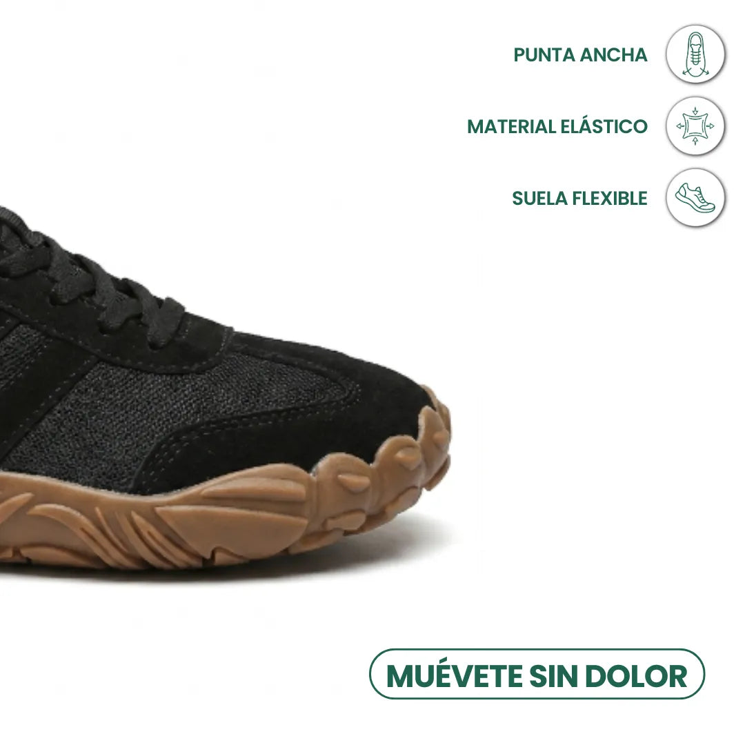 Close-up of the black shoe's wide rounded toe and flexible tan sole, with icons for wide toe, stretch material and flexible sole. 23