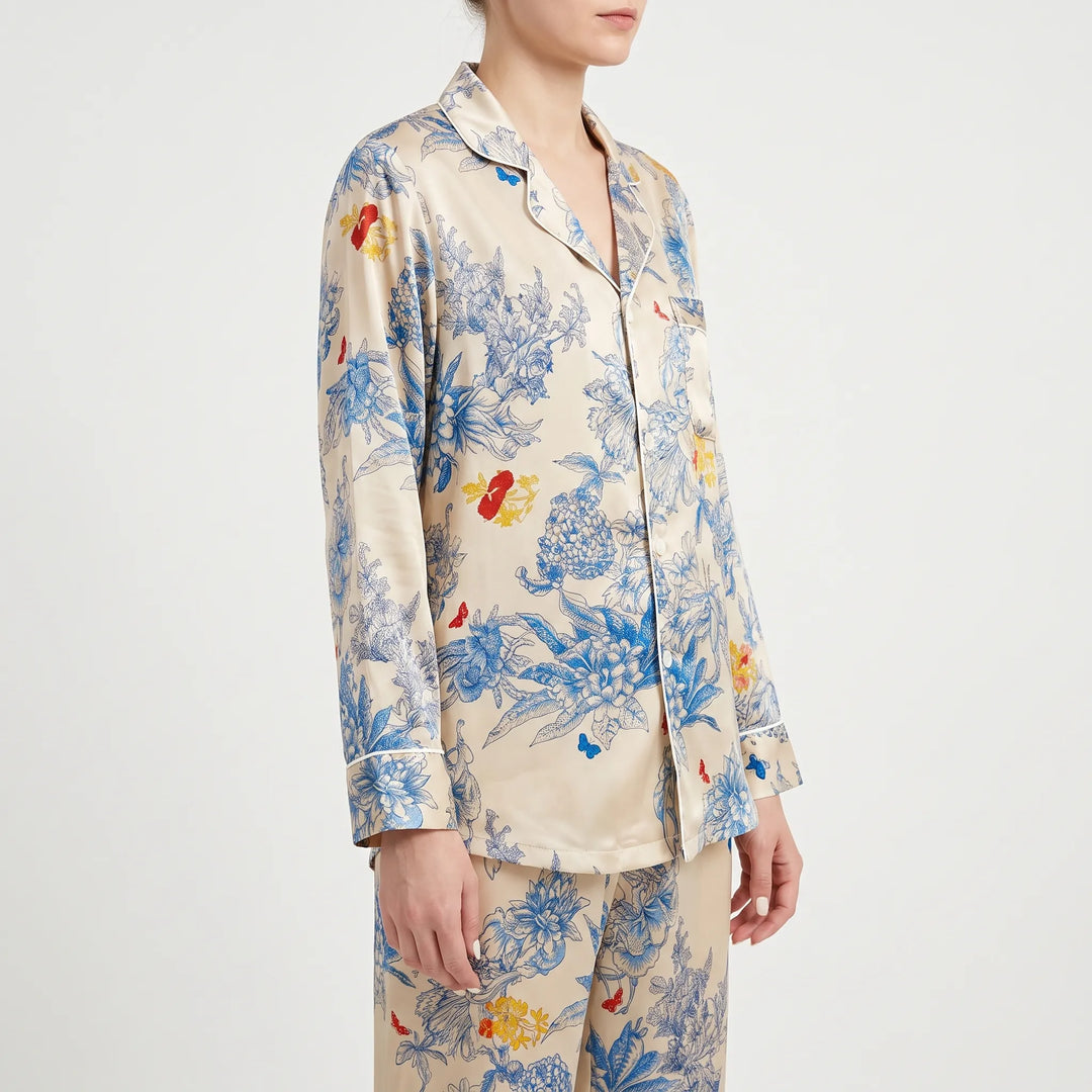 Three-quarter side view of a model in the pajama set, showing the notched collar, white piping and long sleeves. 4