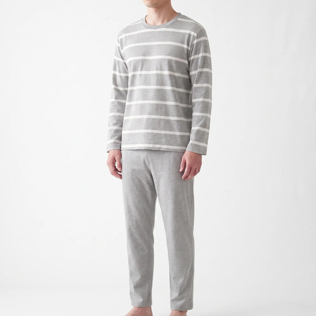 Angled front view of the striped gray pajama set on a model, showing the crew neckline, long sleeves and straight-leg pants. 4