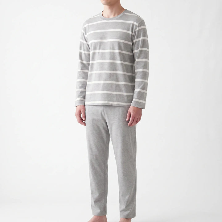 Angled front view of the striped gray pajama set on a model, showing the crew neckline, long sleeves and straight-leg pants. 4