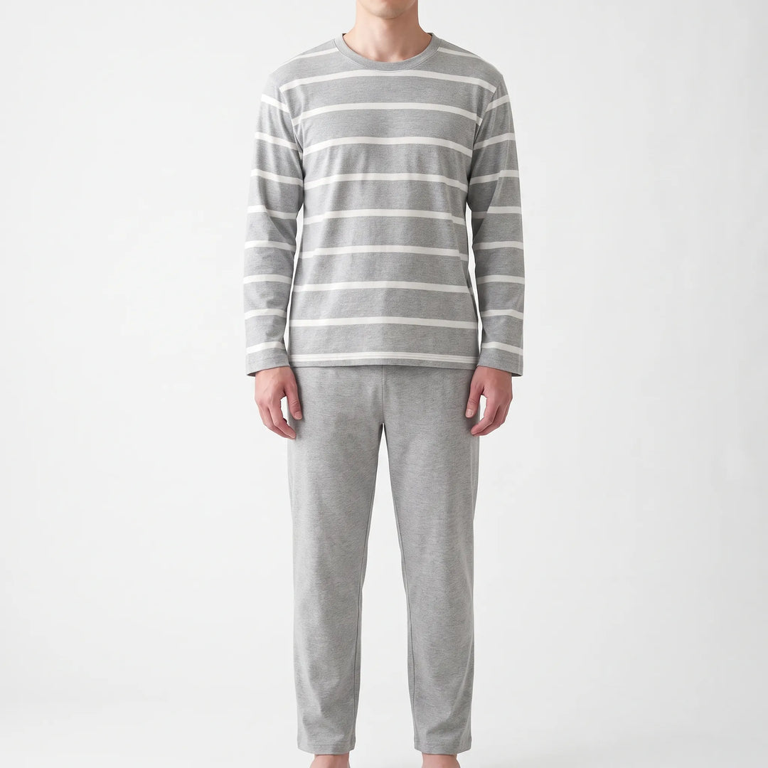 Straight-on front view of the model wearing the gray pajama top with white horizontal stripes and plain gray pants. 6