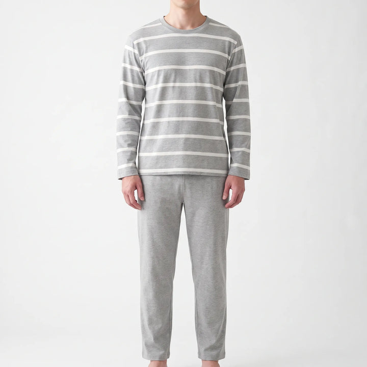 Straight-on front view of the model wearing the gray pajama top with white horizontal stripes and plain gray pants. 6