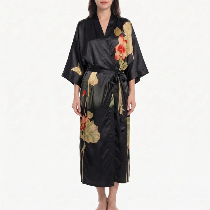 Model in a black satin kimono robe with large red-orange blossoms and pale green lotus leaves, tied with a black belt. 15