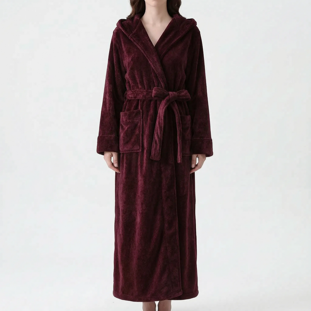 Model wearing the long hooded robe in deep burgundy with a plush textured finish, tied at the waist with a bow. 9