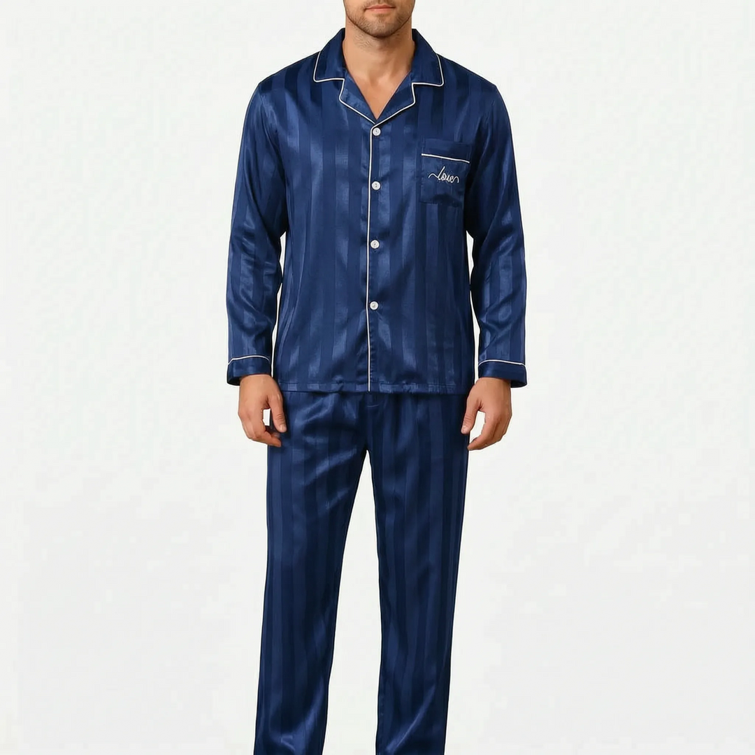 Front view of the navy striped satin pajama set on a model, with white piping on the collar, cuffs and pocket. 7