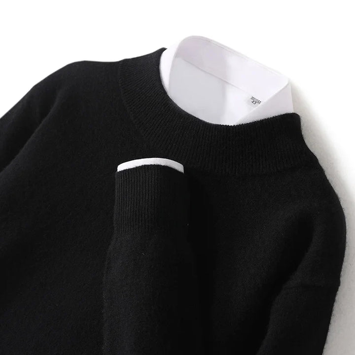 Close-up of the black ribbed mock neckline and cuff with a white shirt collar underneath 17
