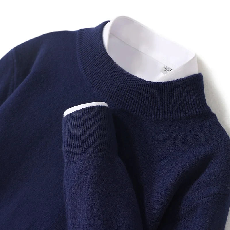Close-up of navy knit sweater with ribbed mock neck and cuff over a white collared shirt 21
