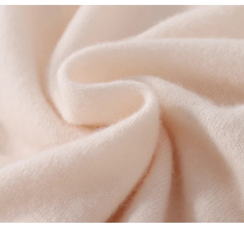 Extreme close-up of soft, fuzzy cream knit fabric folded in a gentle swirl 5