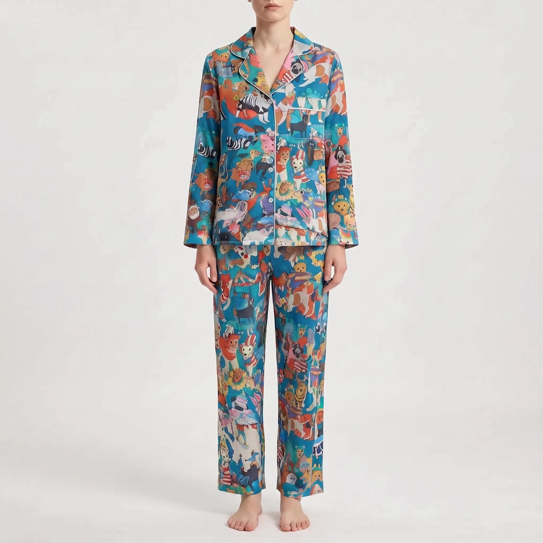 Pajama set in a different print: bright blue with a busy mix of colorful cartoon animals and white piping on the collar. 10