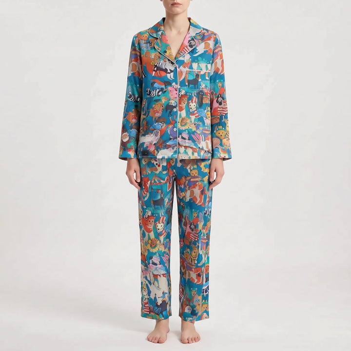 Pajama set in a different print: bright blue with a busy mix of colorful cartoon animals and white piping on the collar. 10