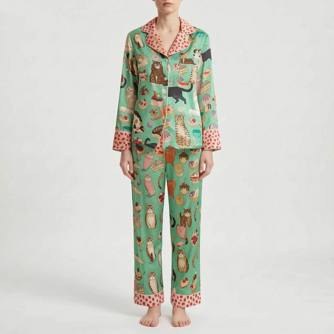 Pajama set in a different print: mint green with cats and pastries, with pink strawberry-dotted collar, cuffs and pant hems. 6
