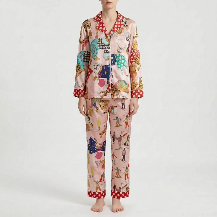 Pajama set in a different print: pink with leopards in patterned sweaters and skiers, with red heart-dotted collar, cuffs and hems. 7