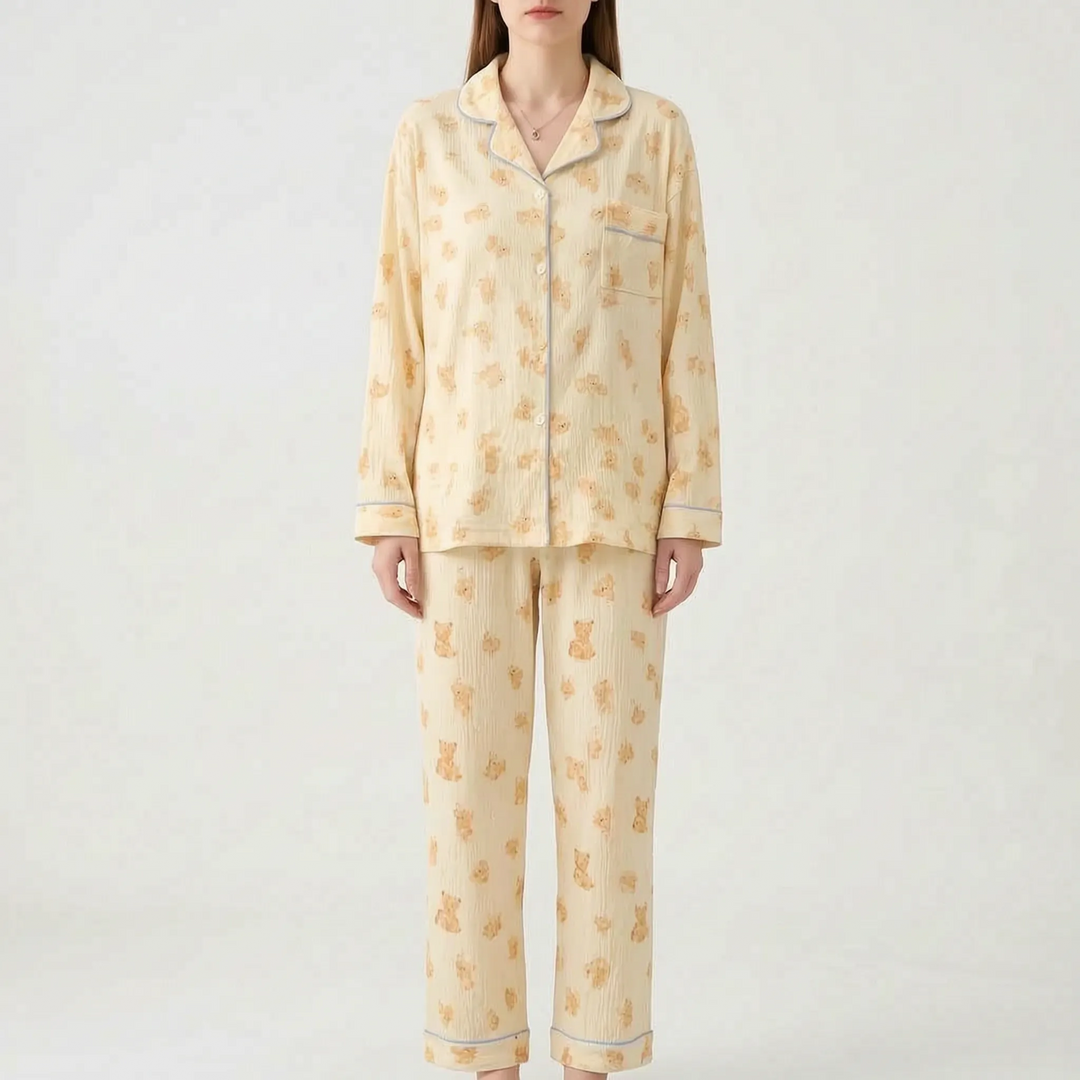Model wearing the pale yellow crinkle-textured pajama set with a teddy bear print and light blue piping. 7