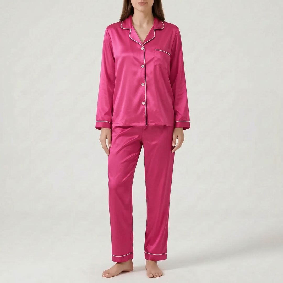 Model wearing a bright fuchsia pink satin pajama set with white piping, white buttons and a chest pocket. 8