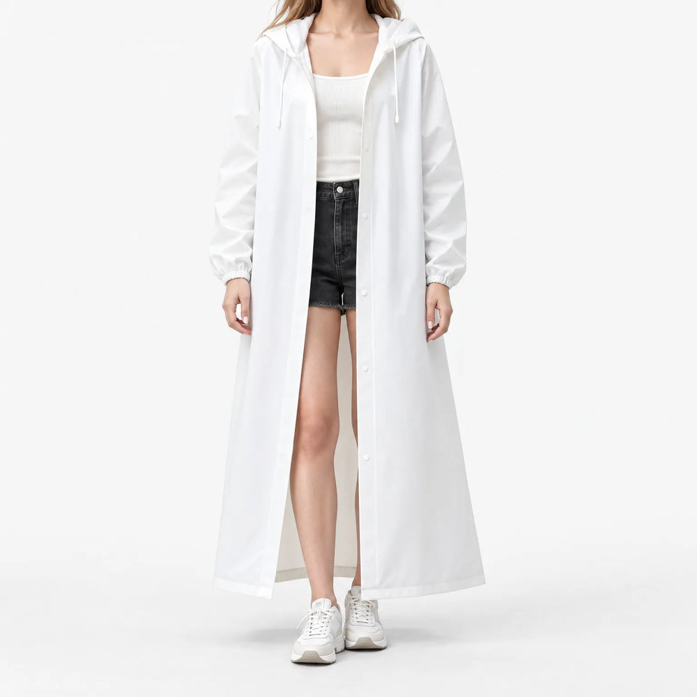 Studio front view of a model in the white hooded coat worn open over a ribbed tank and denim shorts. 2